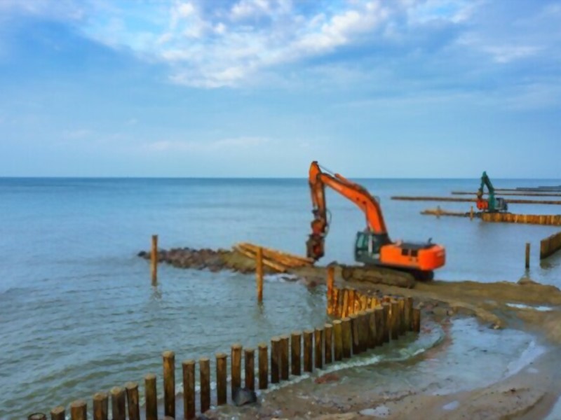 excavators near the sea